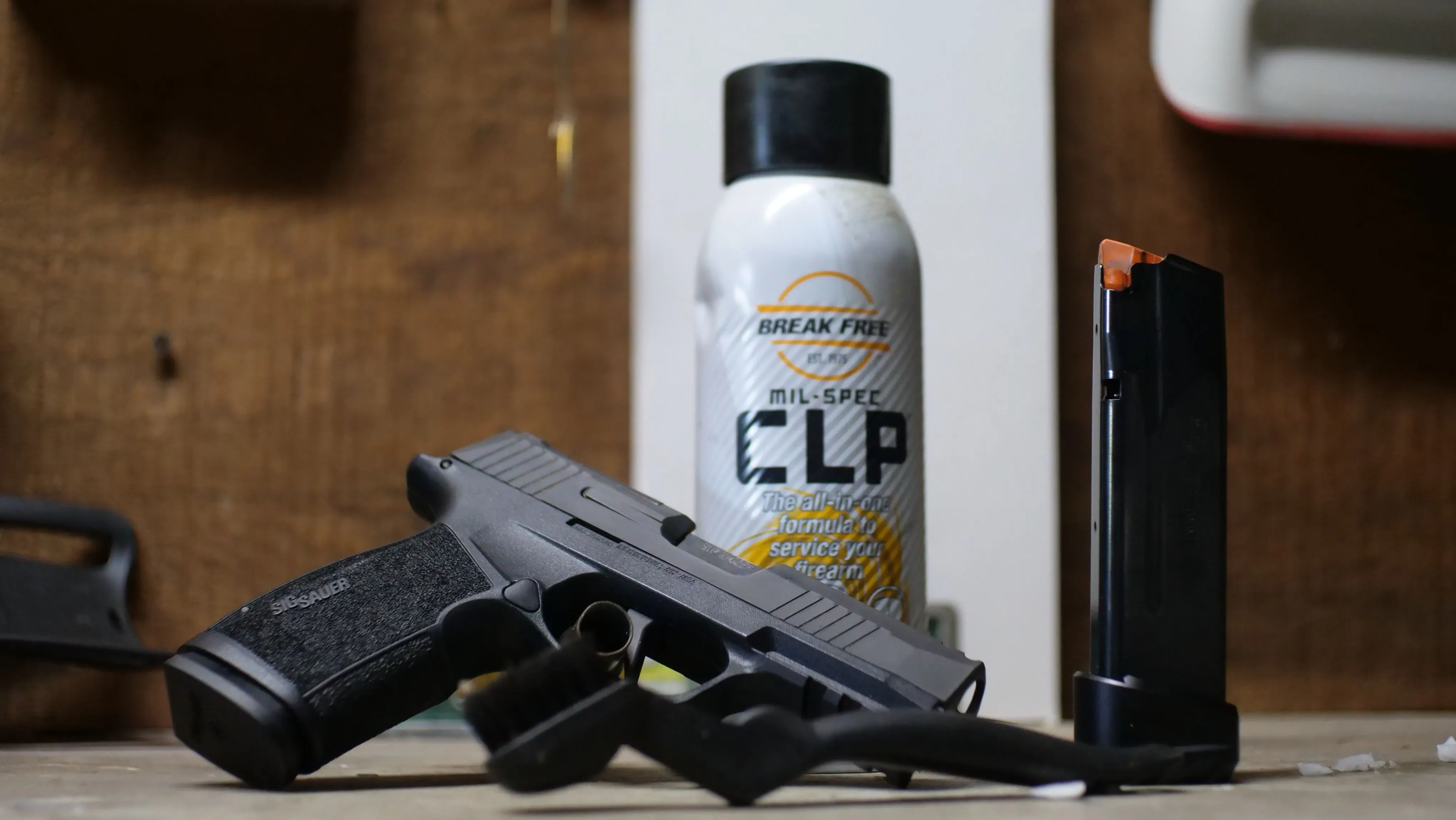 Sig P365 XMacro Comp with recommended cleaning, lubrication and protection product